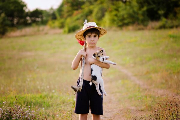 A boy holds a puppy in his hands
