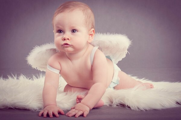 A baby dressed in the guise of an angel