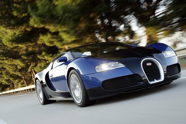 A blue car is racing along the highway