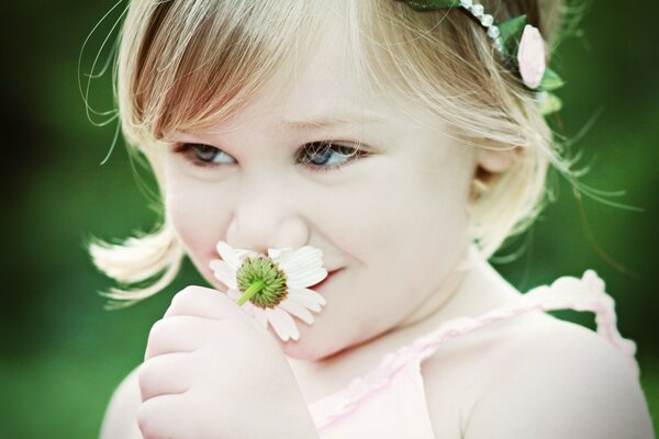 Cheerful girl holding a flower