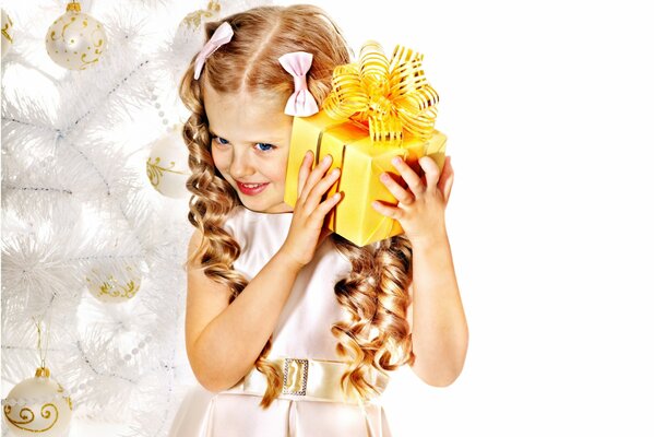 A girl with bows and a gift in anticipation of the new year