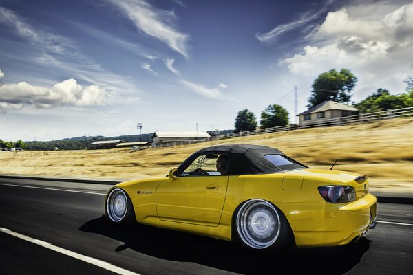 Yellow Honda on the road in motion