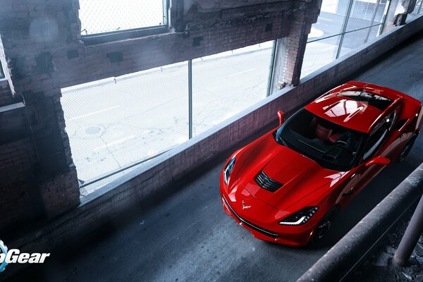 Red Chevrolet rides in a gloomy building