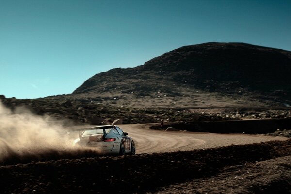 Porsche 911 on a dirt track in the mountains