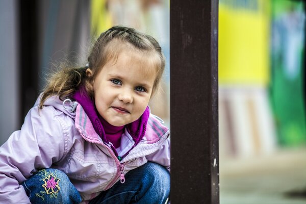 The girl sits and is embarrassed when she is photographed