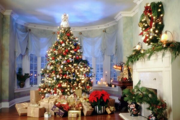 Arbre de Noël décoré dans la salle avec cheminée et un tas de cadeaux