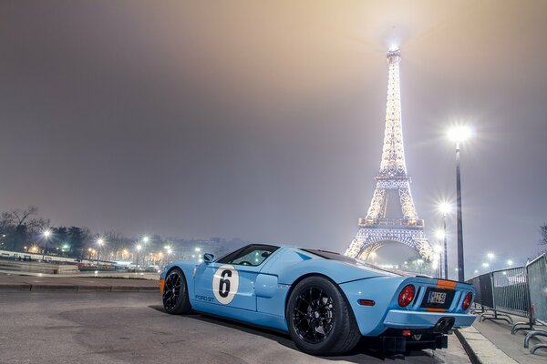 Blue Ford at night at the Eiffel Tower