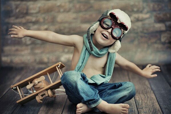 A boy with an airplane depicts a flight