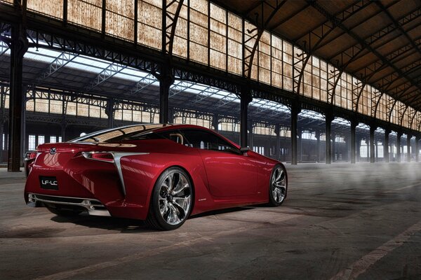 Red Lexus in a covered hangar