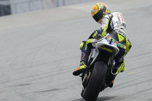 The motorcycle racer confidently looks back at his rivals