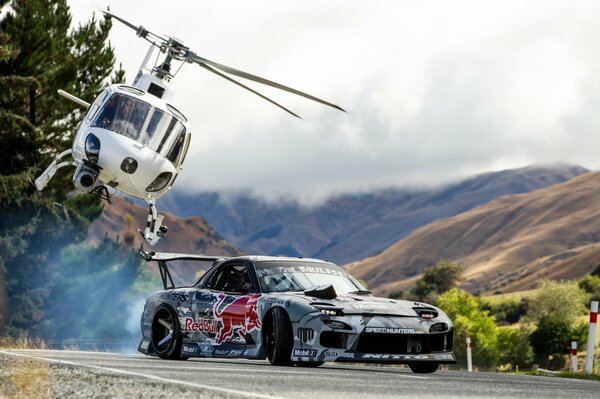 Mazda art with the image of a red bull and a helicopter in the sky