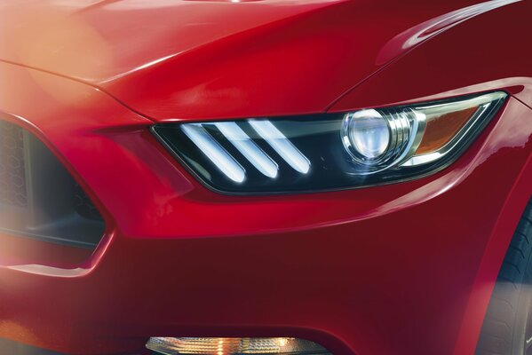 Czerwony Ford Mustang widok przedniego lewego reflektora