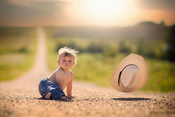 The boy s hat was blown away by the wind