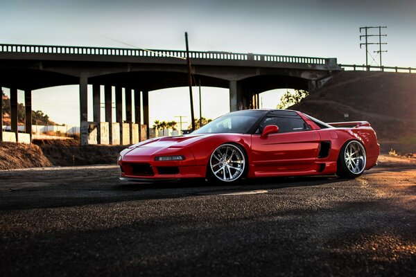 Red Honda nsx on the background of the bridge