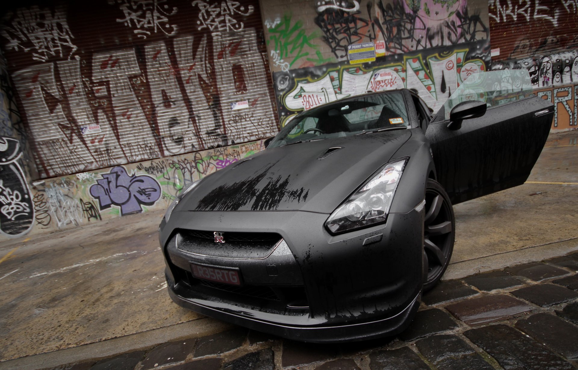 nissan gt-r negro mojado frente graffiti