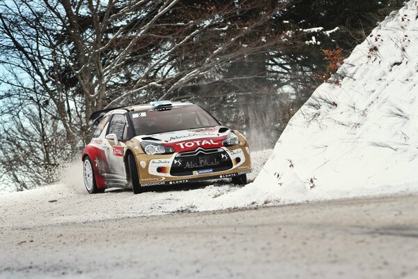 A Citroen car is driving on a snowy road