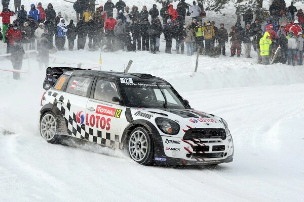 Mini Cooper rides on a snowy road