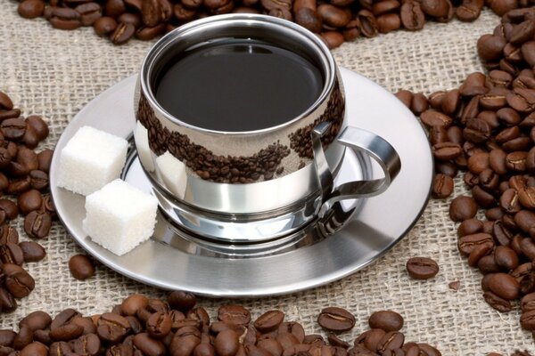 Café en una taza y azúcar en un plato