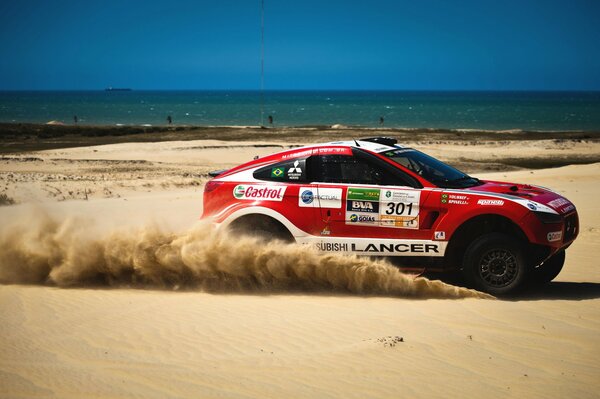 SUV de color rojo en el fondo de la arena