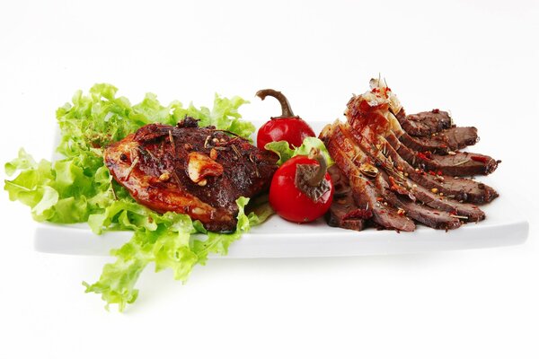 Meat with vegetables on a white background