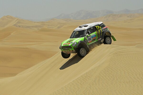 Green mini Cooper in the desert