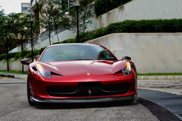 Red ferrari 458 italia on the road