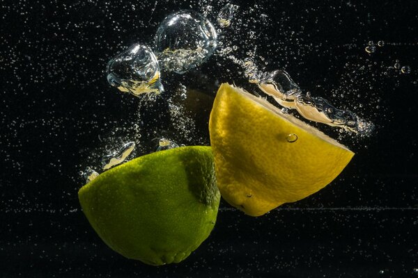 Lemon and lime fall into the water