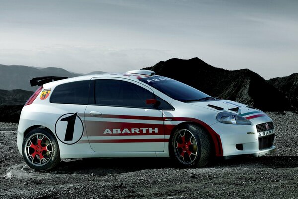 A small white Fiat in the mountains