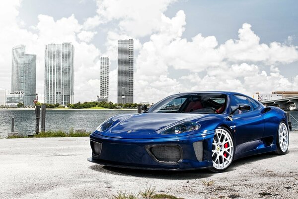 Blue Ferrari supercar on the shore