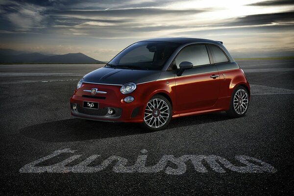 A picture of a small standing car abarth 595 turismo fiat 500