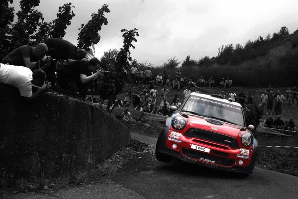 La Mini Cooper rouge entre dans le dérapage sur la course automobile