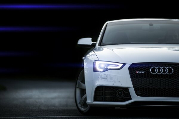 Audi white car with headlights on