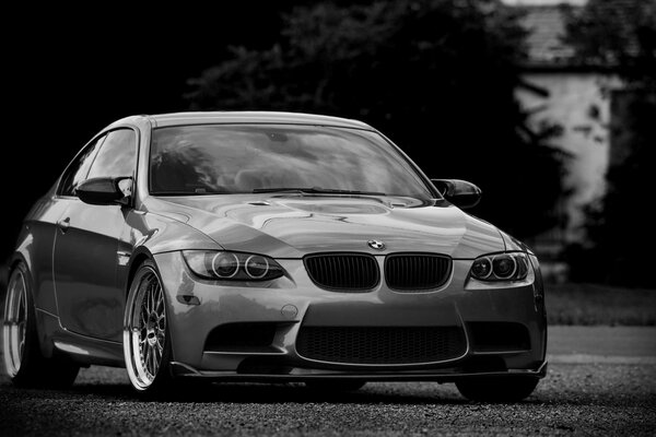 Black and white photo with a sports BMW