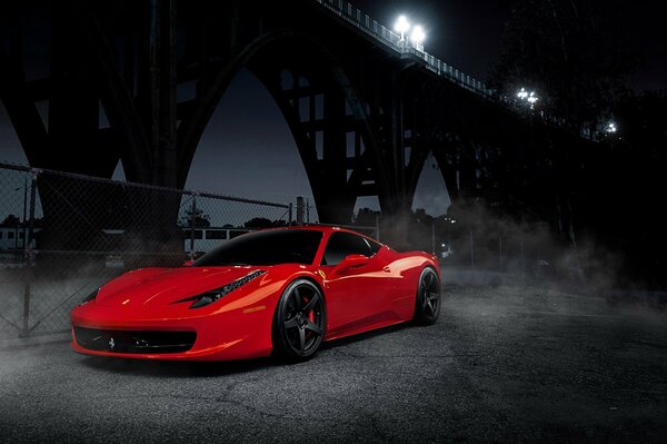 Red Italian Ferrari under the bridge