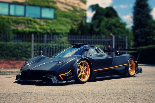 Black hypercar with orange wheels