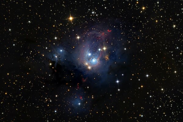 A beautiful nebula against the background of black space and multicolored stars