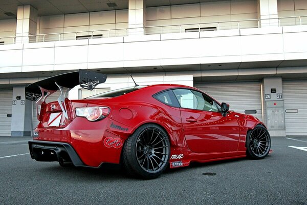 Red sports car at the entrance to the garage