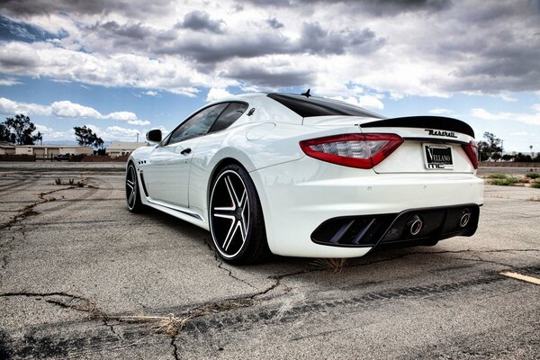 White Maserati on a cloudy sky background