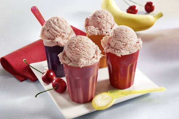 Ice cream in glasses with serving. Fruits and berries near the ice cream