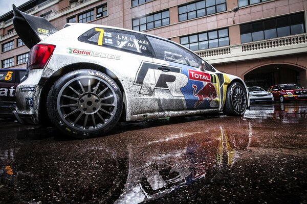 Volkswagen Polo rally after arrival in mud, reflection in a puddle