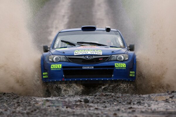 Blue Subaru rides through slush