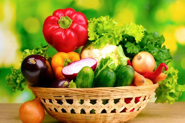 Basket on the table with vegetables and herbs