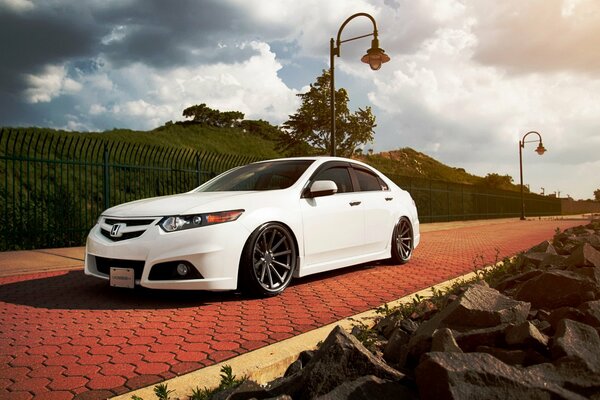 White Honda sporty fast standing on the sidewalk