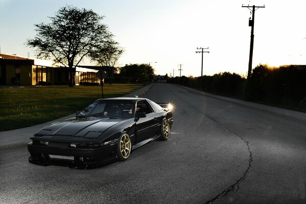 Toyota sports car in a black body at the turn of the highway