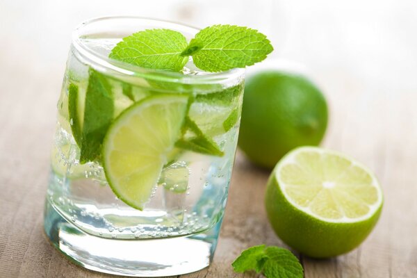 Mojito in a glass on the background of limes