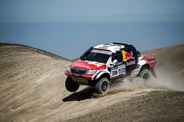 Toyota car on the background of sand and blue sky