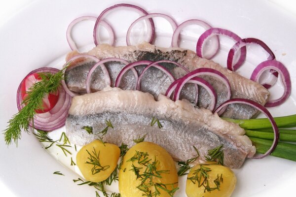 Herring and onion. Fish slicing