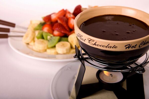 Preheated chocolate for fruit on a plate