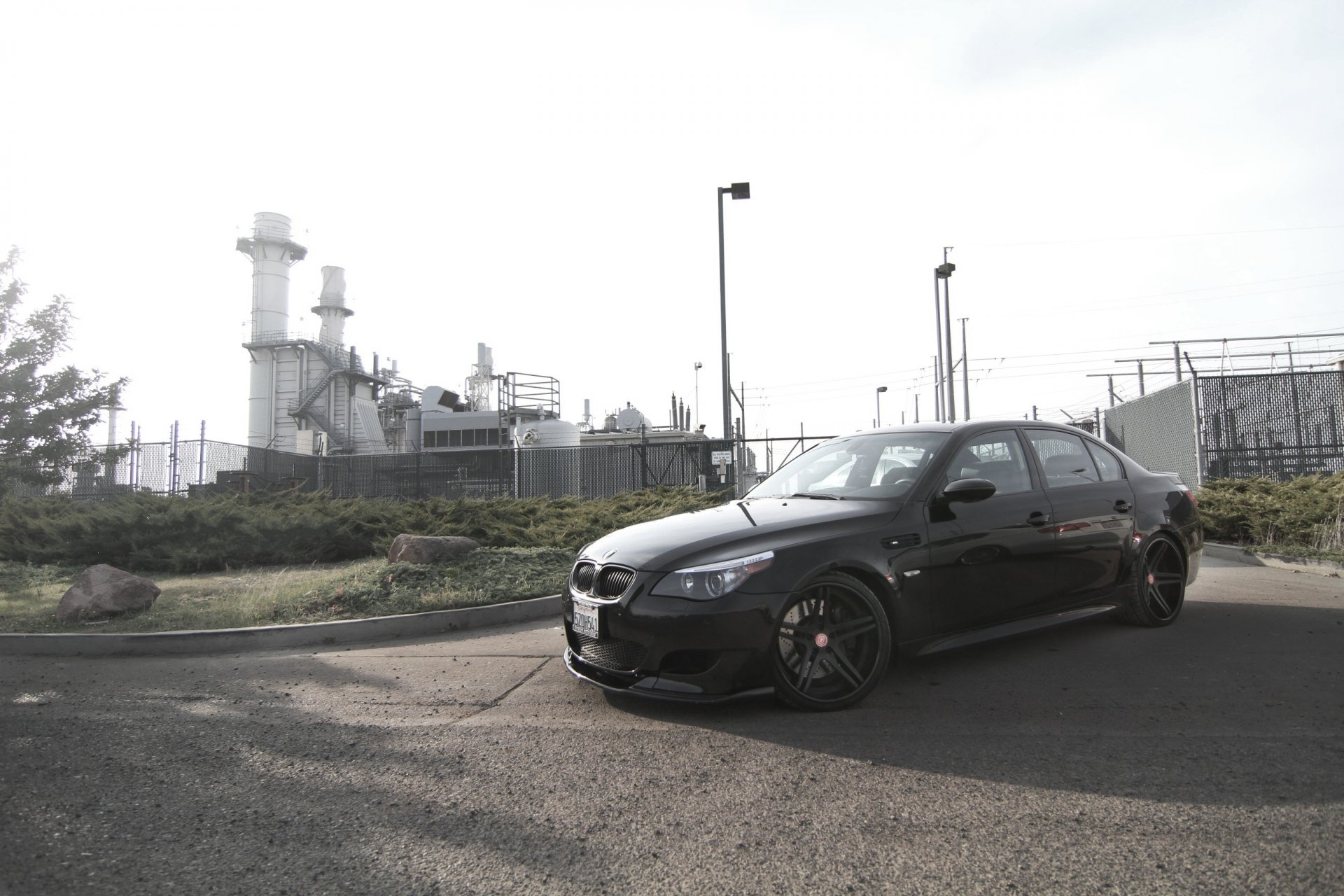 bmw m5 e60 black bmw side view shadow trees shrubbery fence lights rear sky