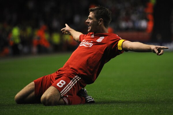 Football player from Liverpool rejoices at scoring a goal